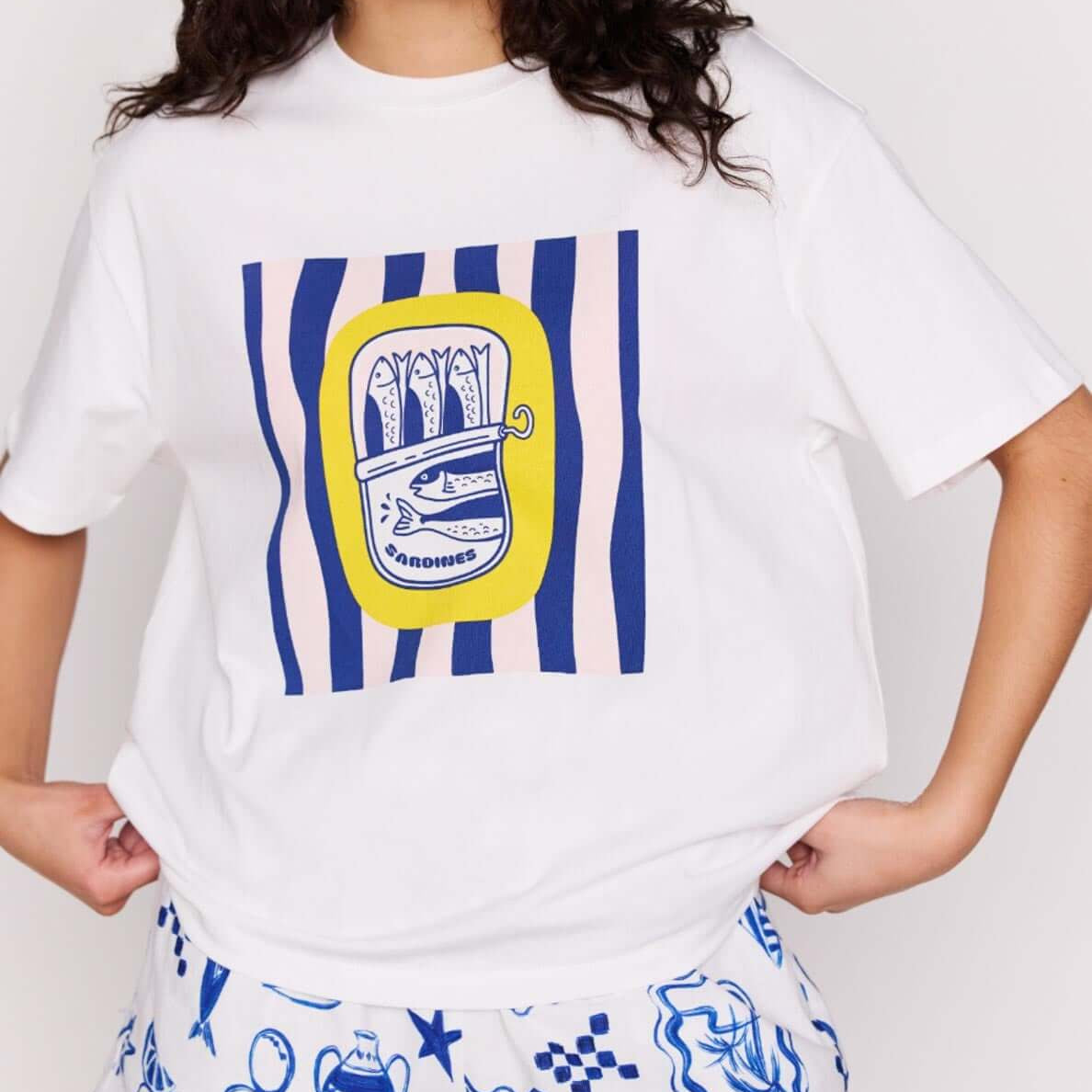 Woman wearing Statement Relaxed Oversized Cotton Tee with Mediterranean print and stylish shorts.
