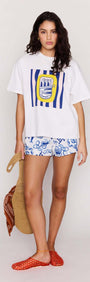 Woman wearing Statement Relaxed Oversized Cotton Tee with Mediterranean print and stylish shorts, ready for summer.