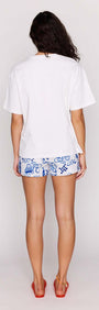 Back view of a woman wearing a Statement Relaxed Oversized Cotton Tee with colorful shorts.