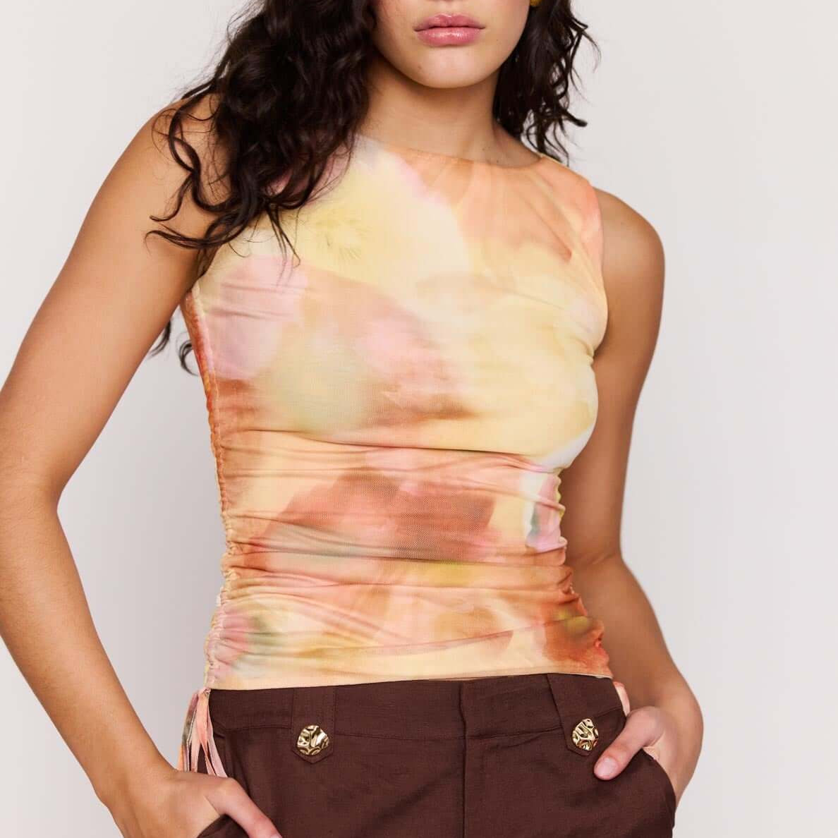 Model wearing Sunset Tonal Drawstring Mesh Top with adjustable side drawstrings and sun-washed print.