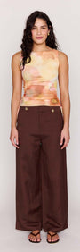 Model wearing the Sunset Tonal Drawstring Mesh Top paired with brown wide-leg pants.