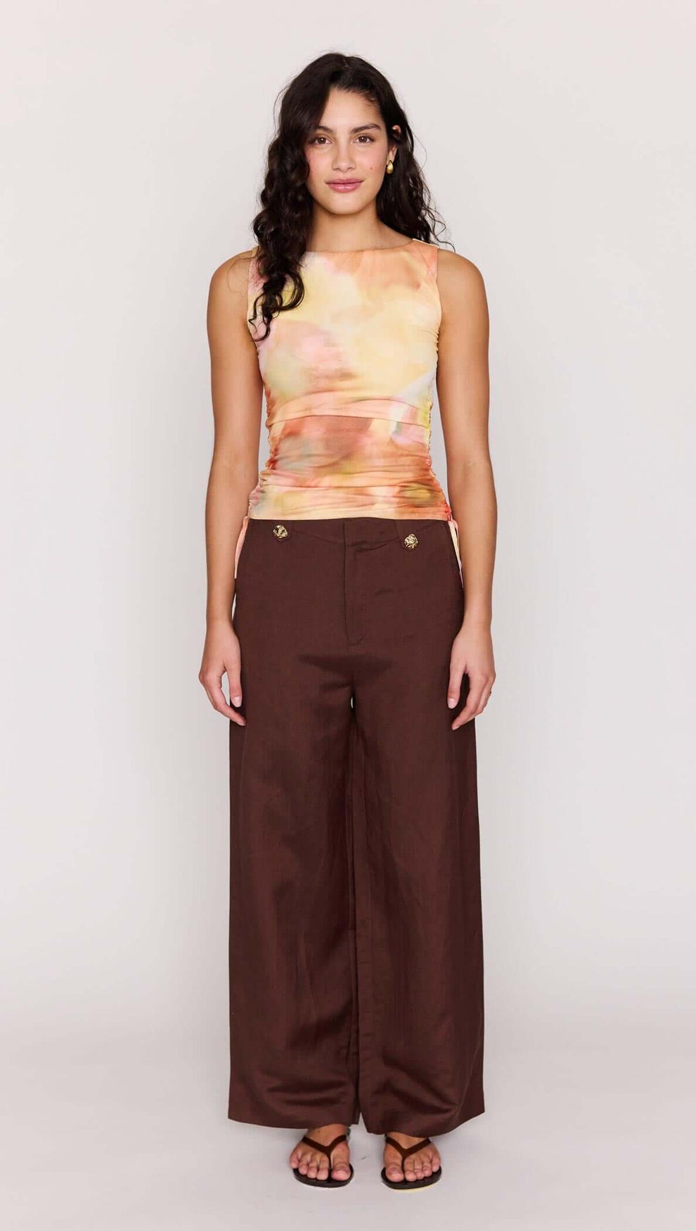 Model wearing the Sunset Tonal Drawstring Mesh Top paired with brown wide-leg pants.