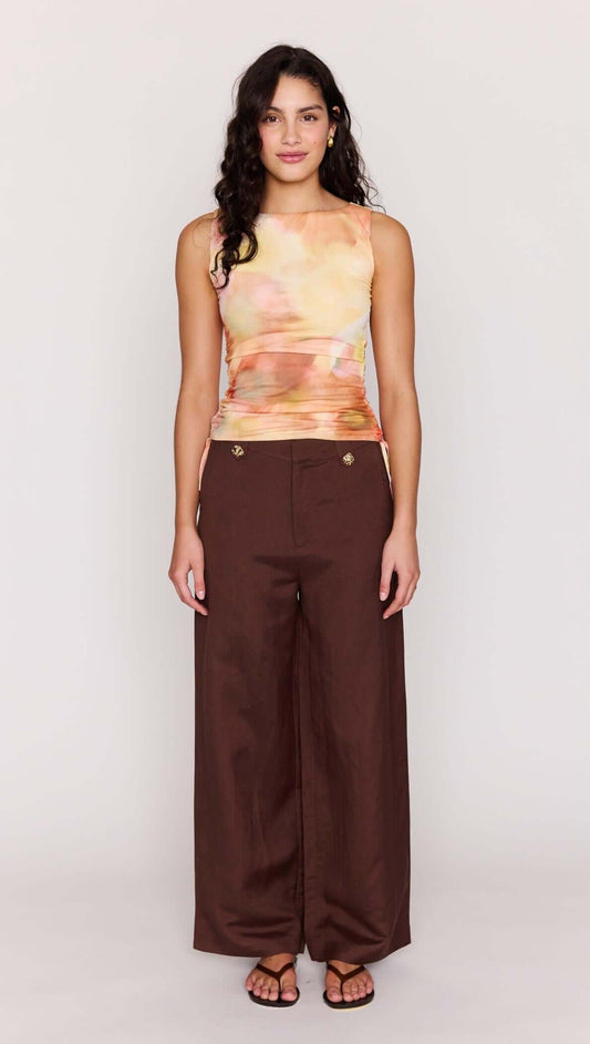 Model wearing the Sunset Tonal Drawstring Mesh Top paired with brown wide-leg pants.