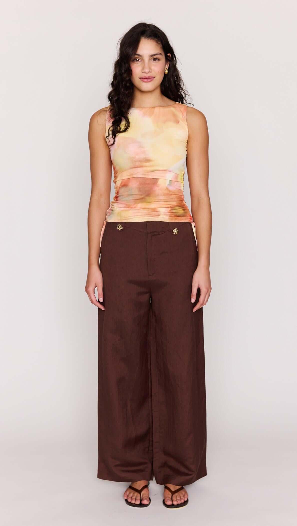 Model wearing the Sunset Tonal Drawstring Mesh Top paired with brown wide-leg pants.