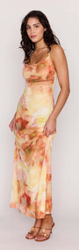 Model wearing the Sunset Tonal Mesh Maxi Dress featuring a draped neckline and floral print.
