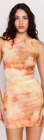 Model wearing the Sunset Tonal Mesh Mini Dress featuring a sun-washed watercolor print and flattering ruching.