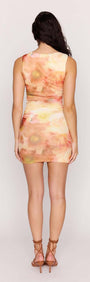 Back view of the Sunset Tonal Mesh Mini Dress with watercolor-inspired print and subtle ruching.