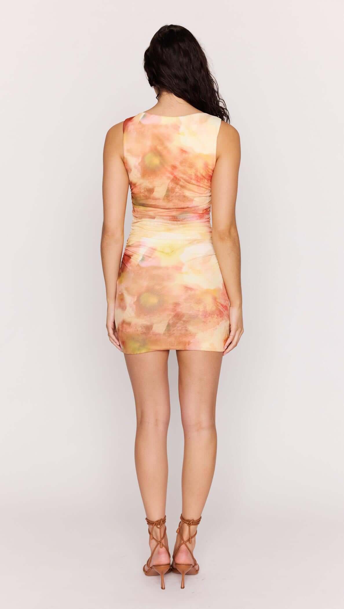 Back view of the Sunset Tonal Mesh Mini Dress with watercolor-inspired print and subtle ruching.