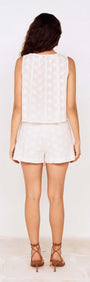 Model showcasing the back view of the Tie Detail Broderie Anglaise Cotton Skort outfit.