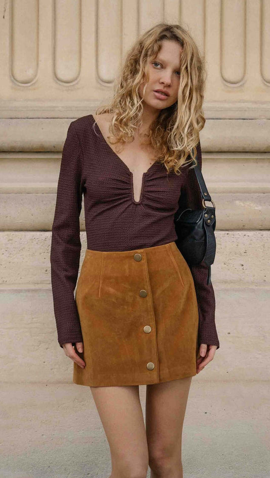 Model wearing U Wire Textured Jersey Top in Chocolate with a suede skirt, showcasing a stylish and trendy outfit.