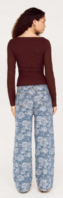 Woman wearing U Wire Textured Jersey Top in Chocolate with stylish floral wide-leg pants.