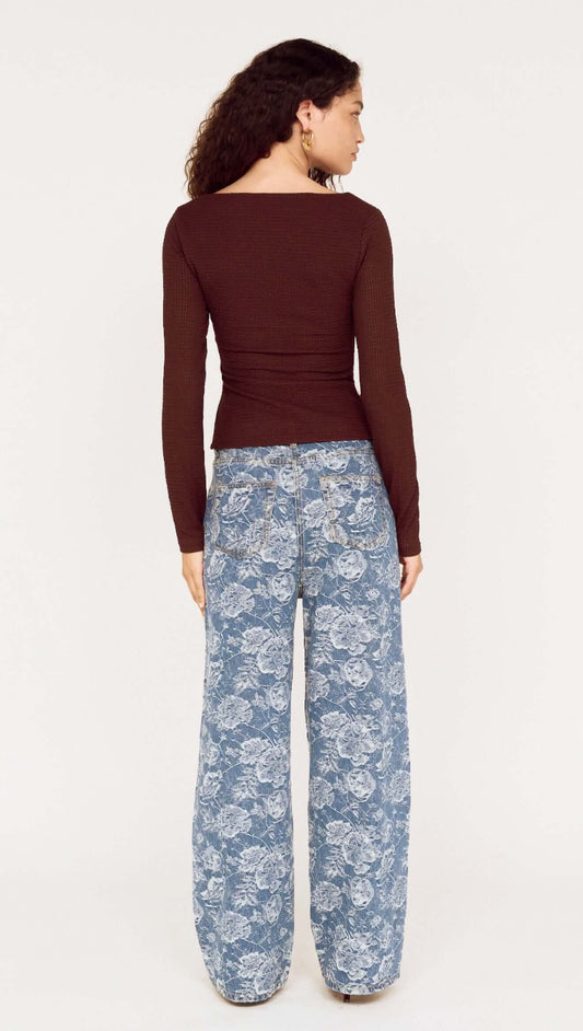 Woman wearing U Wire Textured Jersey Top in Chocolate with stylish floral wide-leg pants.