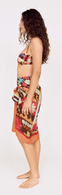 Model showcasing the Vinatage Coastal Print Long Sarong styled for a resort look, featuring vibrant floral patterns.