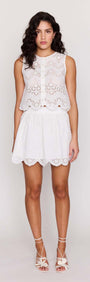 White Broderie Anglaise Mini Skirt paired with matching broderie top, showcasing a chic summer outfit.