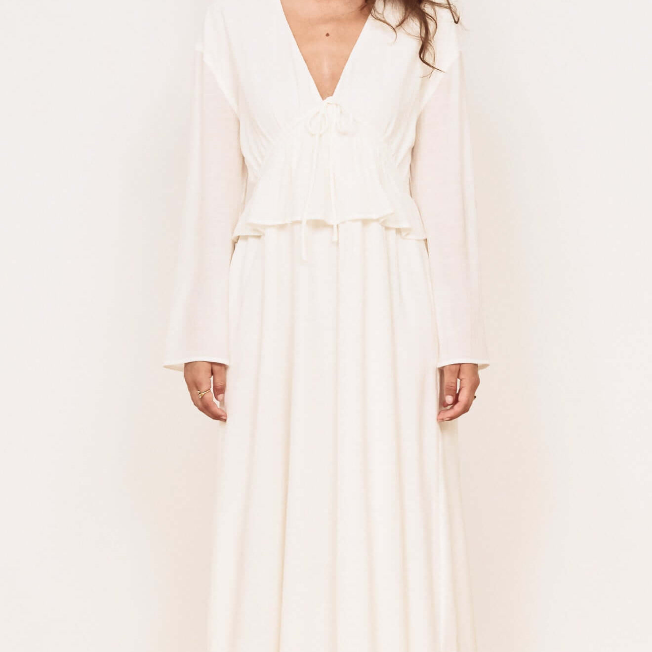Model wearing a White Crinkle Tie Front Midi Dress with a V-neck and layered peplum details.