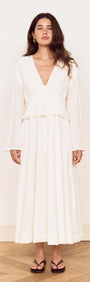 Model wearing a White Crinkle Tie Front Midi Dress with a V-neck and layered peplum details.