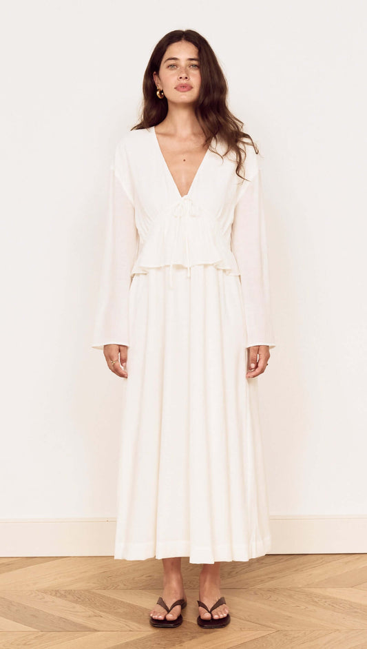 Model wearing a White Crinkle Tie Front Midi Dress with a V-neck and layered peplum details.