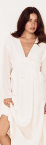 Woman wearing a White Crinkle Tie Front Midi Dress with a soft V-neckline and relaxed long sleeves.