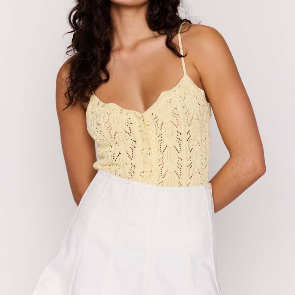 Model wearing a White Denim Panel Mini Skirt with a lace top, showcasing a stylish and modern outfit.