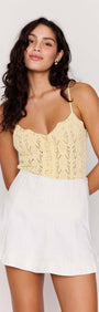 Model wearing a White Denim Panel Mini Skirt with a lace top, showcasing a stylish and modern outfit.