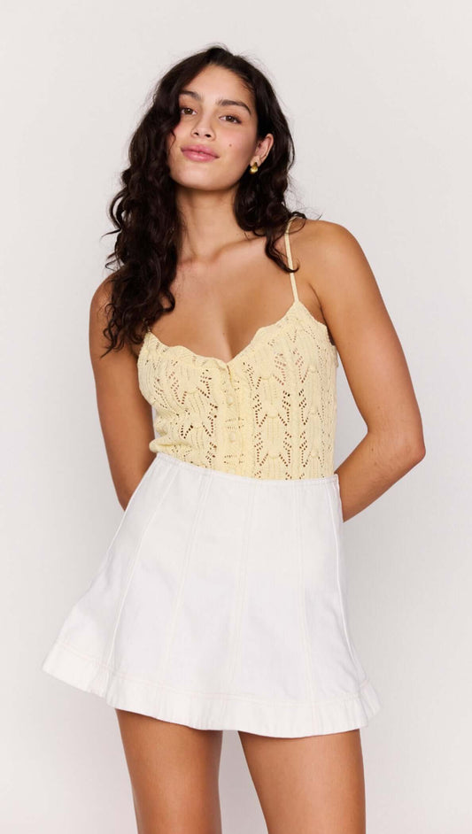 Model wearing a White Denim Panel Mini Skirt with a lace top, showcasing a stylish and modern outfit.