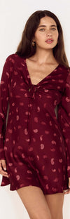 Model wearing the Wine Satin Paisley Knot Front Bias Mini Dress featuring a V-neckline and flared sleeves.