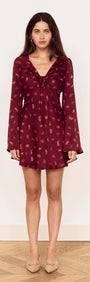 Model wearing a Wine Satin Paisley Knot Front Bias Mini Dress with long flared sleeves and a V-neckline.