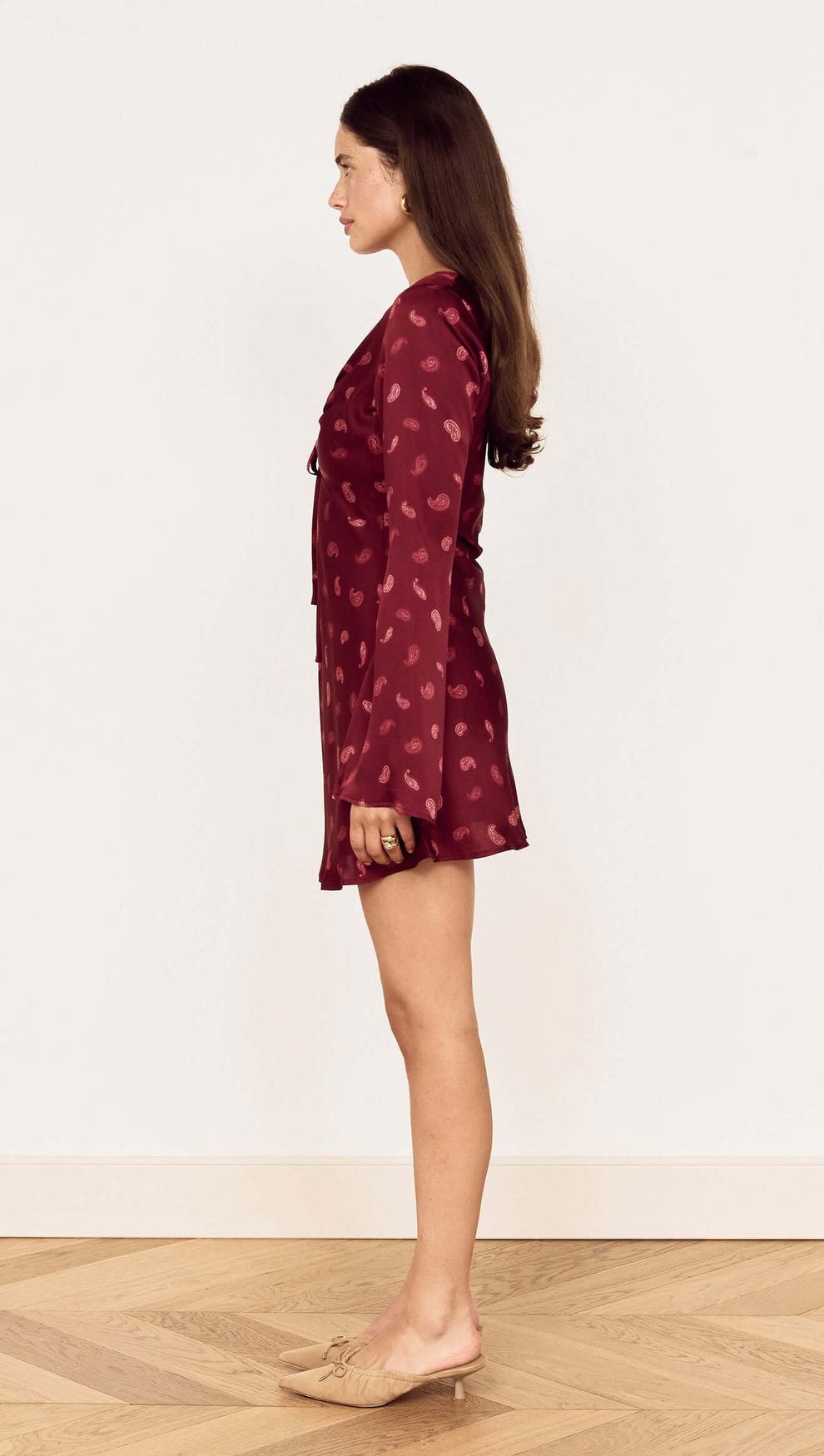 Wine Satin Paisley Knot Front Bias Mini Dress showcased from the side, featuring flared sleeves and a rich paisley print.