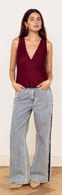 Model wearing Wine Satin V-Neck Cami Top with relaxed denim for a stylish look.