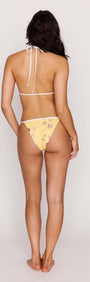 Yellow Printed Cheeky Strappy Bikini Bottoms on model from the back, showcasing minimal coverage and stylish design.