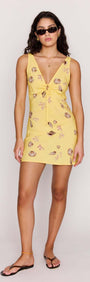 Yellow Printed ECOVERO Summer Mini Dress on a model, showcasing its flattering V-neckline and seashell print.