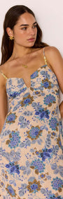 Linen Blend Blue Floral Bias Midi Dress worn by a model, featuring floral print and adjustable straps.