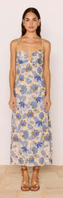 Linen Blend Blue Floral Bias Midi Dress displayed on a model with adjustable straps and blue floral print.