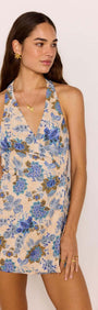 Linen Blend Blue Floral Halter Playsuit modeled by a woman, showcasing the floral design and halter neck style.