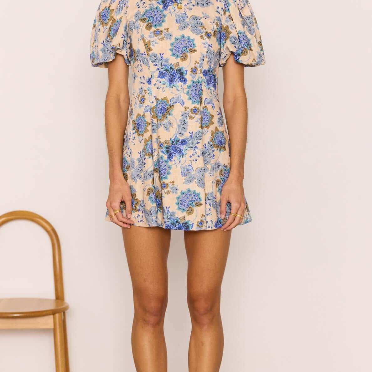 Linen Blend Blue Floral Mini Dress modeled by a woman with puff sleeves and floral design, ideal for summer wear.