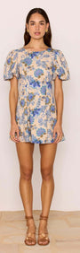 Linen Blend Blue Floral Mini Dress modeled by a woman with puff sleeves and floral design, ideal for summer wear.