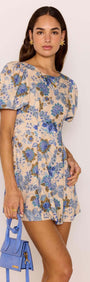 Linen Blend Blue Floral Mini Dress modeled by a woman, showcasing puff sleeves and a flattering A-line silhouette.