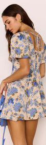 Linen Blend Blue Floral Mini Dress showcasing puff sleeves and open back with tie detail, perfect for summer outings.