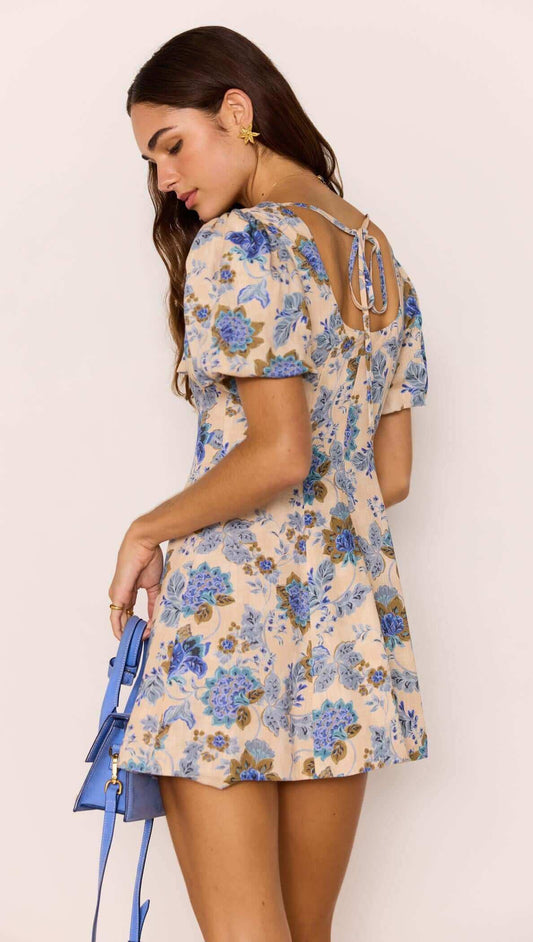 Linen Blend Blue Floral Mini Dress showcasing puff sleeves and open back with tie detail, perfect for summer outings.