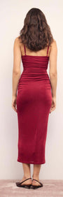 Red Slinky Midi Dress showcasing a figure-hugging silhouette from the back, featuring a rich wine hue and delicate spaghetti straps.