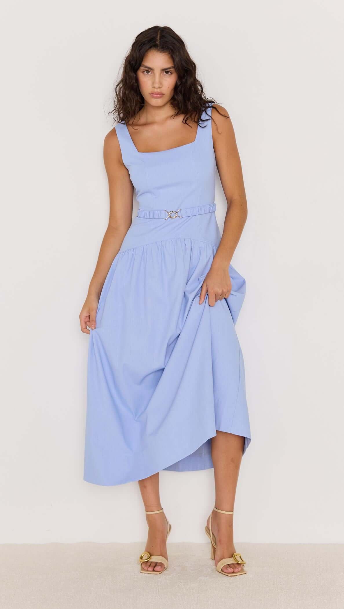 Model wearing a sky blue drop waist belted midi dress, showcasing a flattering silhouette and elegant design.