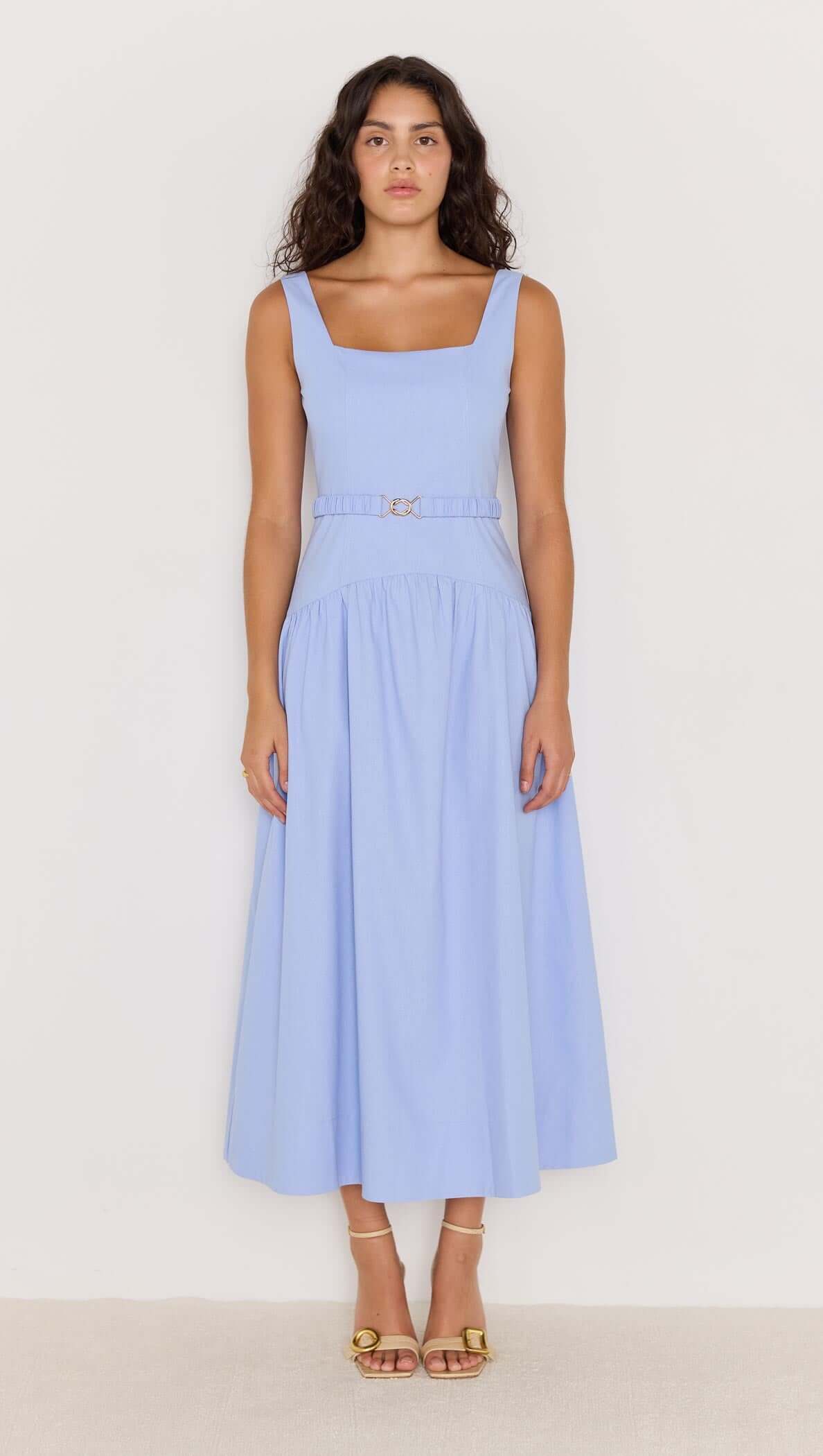 Model wearing a sky blue drop waist belted midi dress, showcasing a flattering silhouette and elegant design.