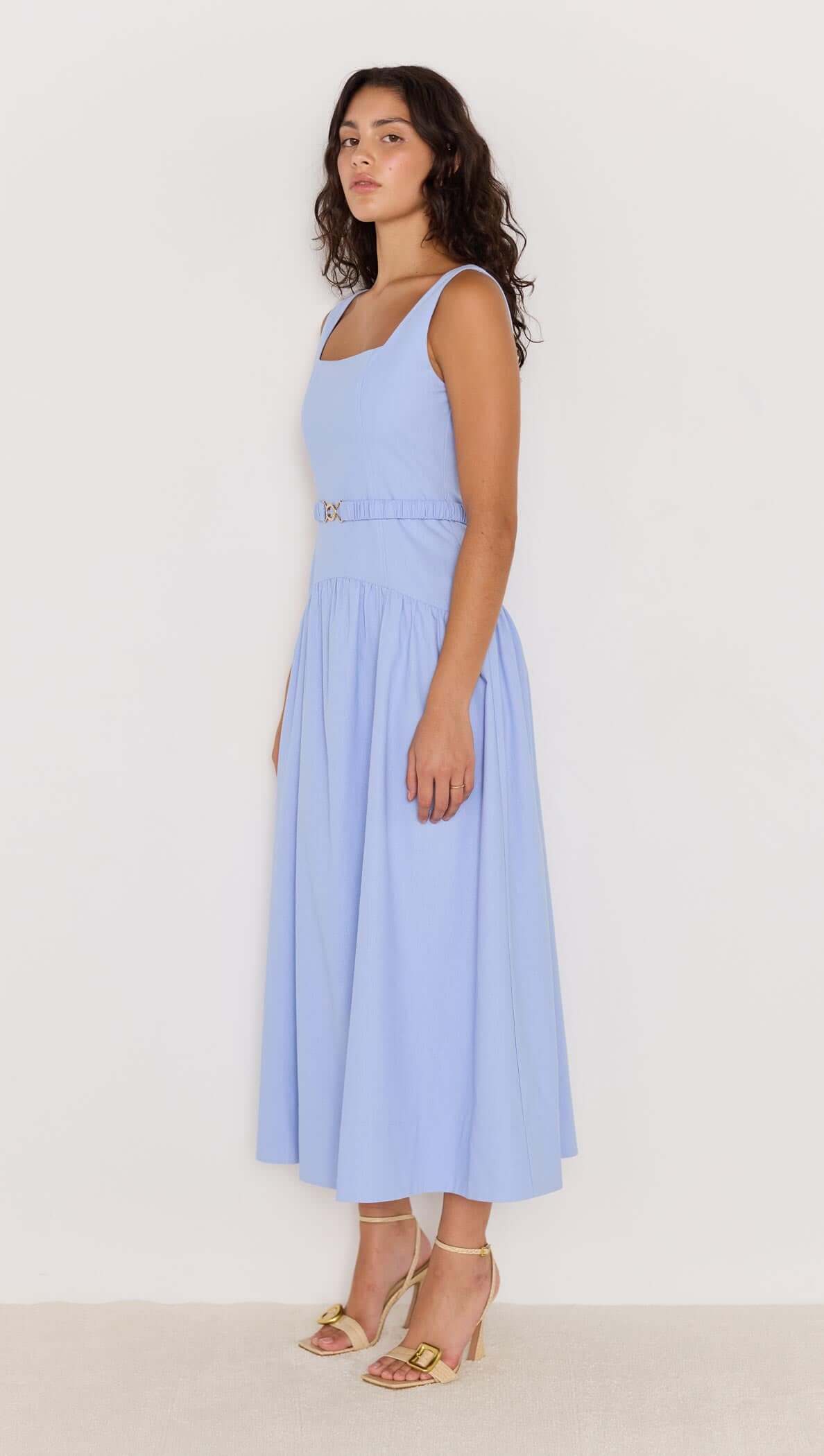Sky blue drop waist belted midi dress worn by a model, featuring a square neckline and flowy skirt.