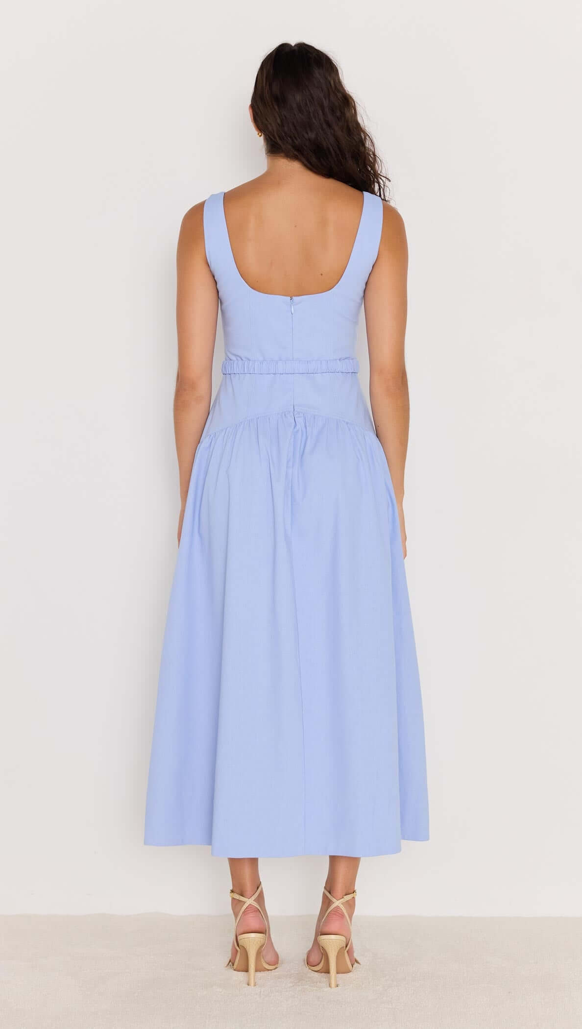 Model wearing a sky blue drop waist belted midi dress, showcasing a flattering silhouette and elegant design.