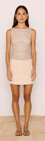 Beige A-Line Cotton/Linen Blend Mini Skirt paired with a striped tank top, perfect for casual summer outings.