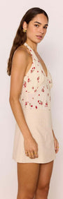 Beige A-Line Cotton/Linen Blend Mini Skirt displayed on a model, showcasing its floral design and flattering silhouette.