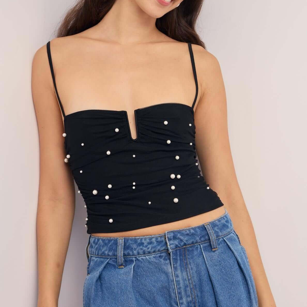 Pearl Embellished Black Mesh Crop Top worn by model, featuring pearl details and a flattering sweetheart neckline.
