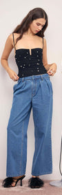 Woman wearing a Pearl Embellished Black Mesh Crop Top with denim pants and stylish heels.
