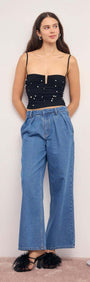 Pearl Embellished Black Mesh Crop Top paired with high-waisted denim pants and stylish heels.