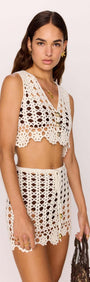 Model wearing the Resort Crochet Knit Mini Skirt in White paired with a matching crochet crop top.